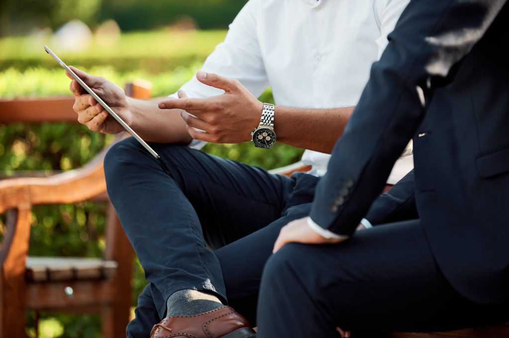 Two people on a bench, having a conversation is one of the best ways to find new coaching clients if you're just getting started as a life coach.